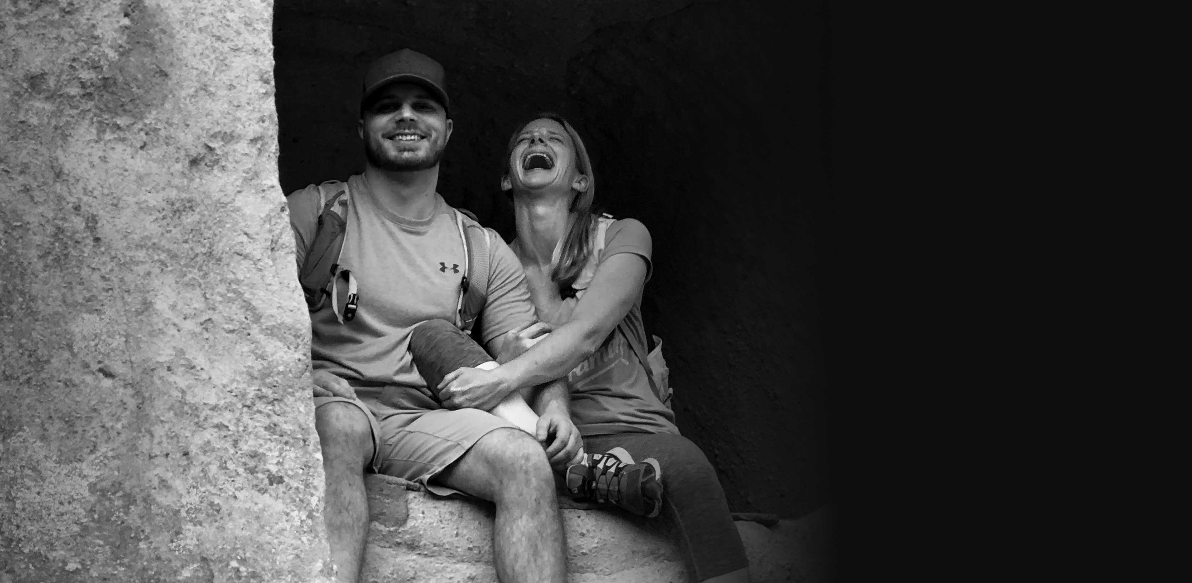 Matt and Chrissy laughing in a cave